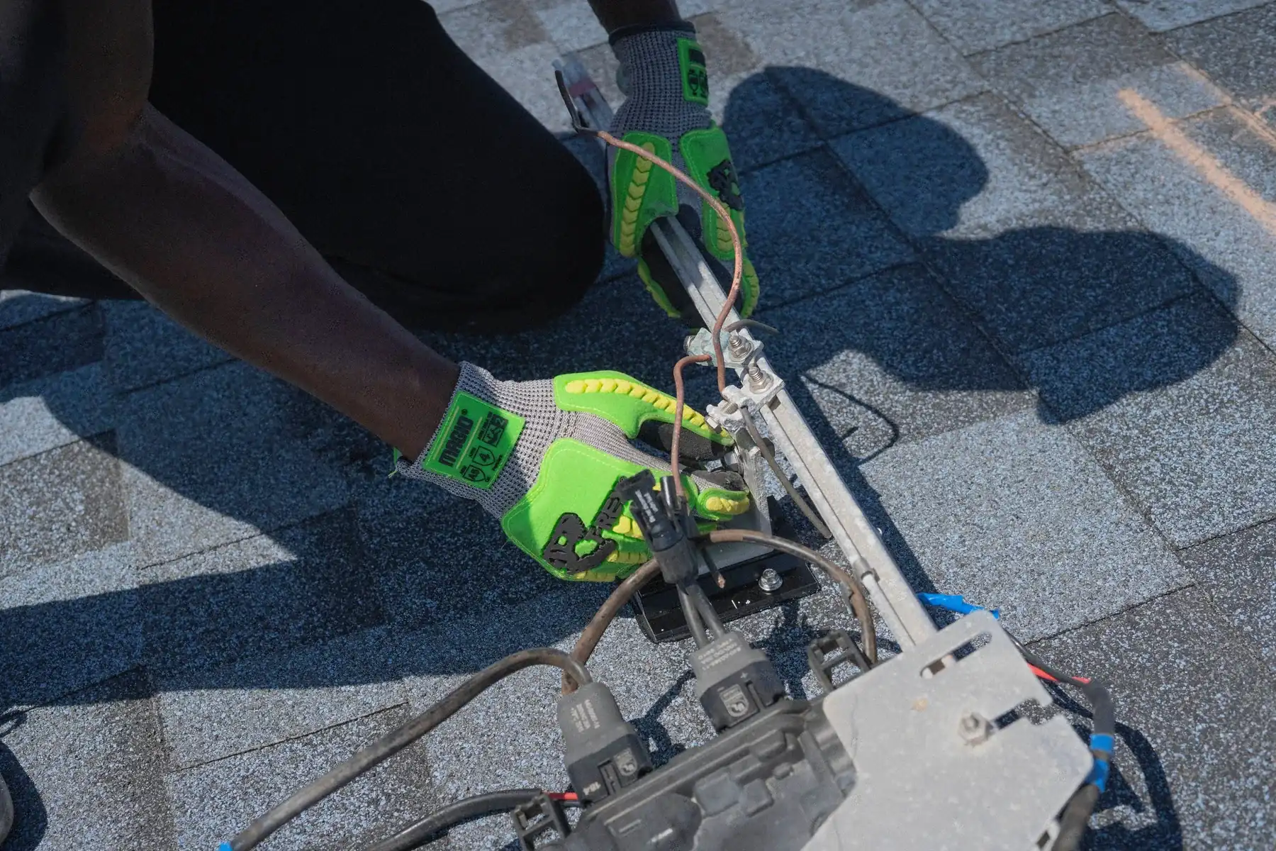 Solar installer working on a roof with tools
